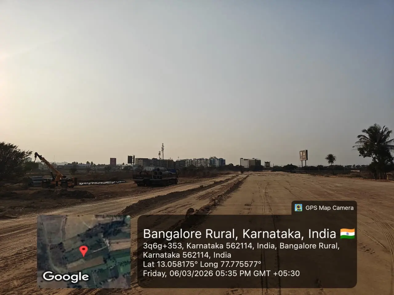 Featured Image of Sobha One Residences Site Progress March 2026 - Wide internal road with construction trucks and distant Whitefield skyline, GPS-stamped Amanidoddakere Village